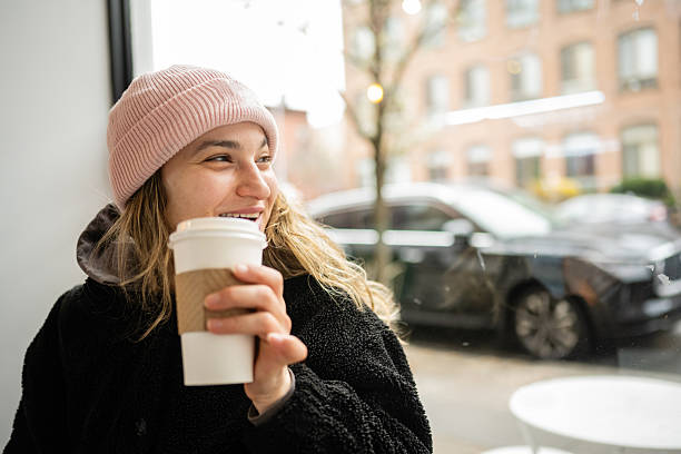 istock Woman Sits Inside Brooklyn Cafe on Cold Rainy Day in NYC 2209810818