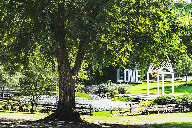 istock White Chairs Set Amid Lush Greenery for Outdoor Wedding 2209811336
