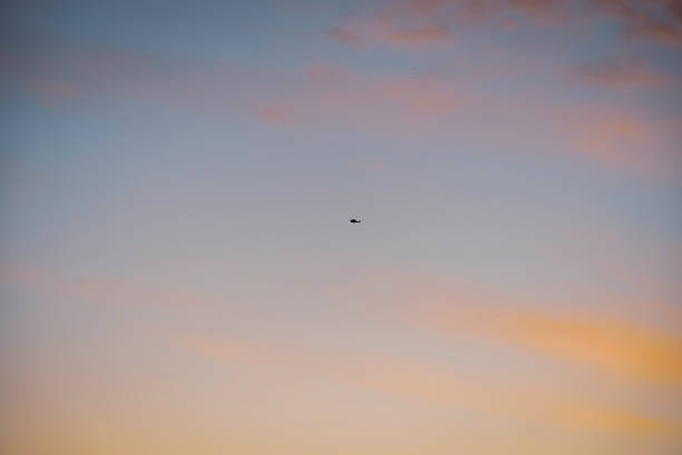 istock Helicopter flying in the sunset sky 2209811363