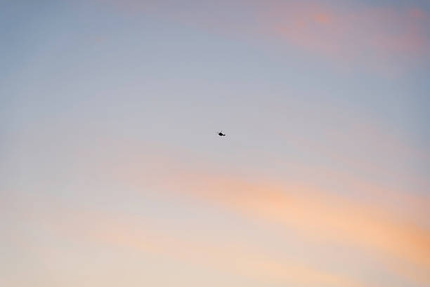 Helicopter flying in the sunset sky