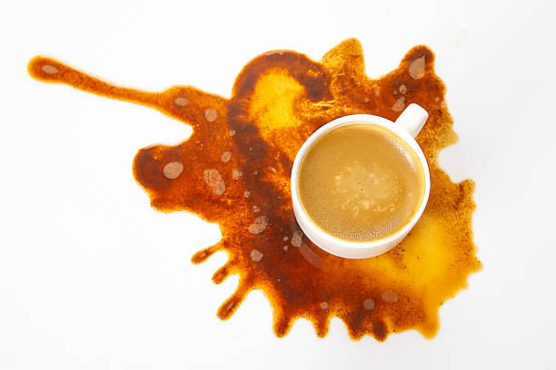 istock A white coffee cup with espresso sits amidst a chaotic brown spill, blending art and accident on a minimalist white surface 2209817850