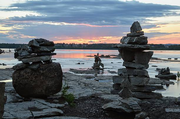istock Tranquil Sunset Over Rock Sculptures by the River 2209821464