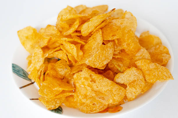istock A pile of puffed potato chips snacks on a white painted plate 2209821888
