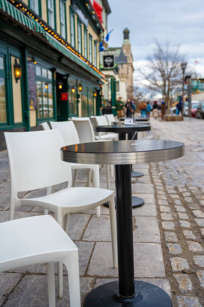 istock Row of tables and chairs on patio restaurant 2209823619