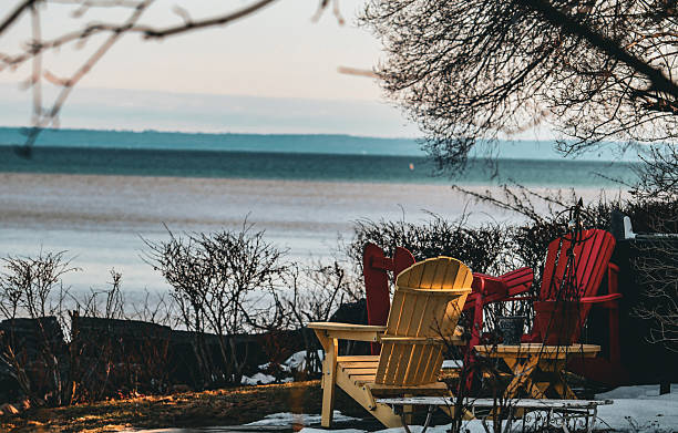 istock Colorful Adirondack Chairs Facing the Lake. 2209825352