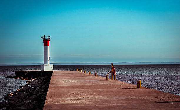 istock Lighthouse at the End of a Tranquil Pier 2209825376