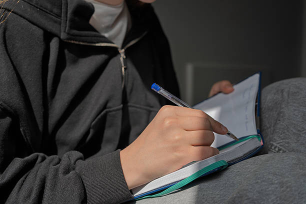 istock Person writing in the notebook, making important notes - Stock photo 2209825446