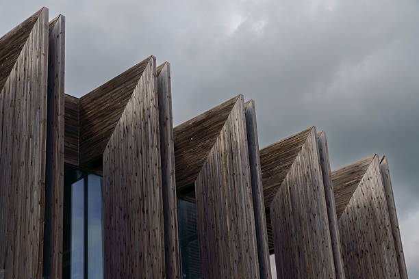Striking architectural design featuring a modern wooden facade against a cloudy sky