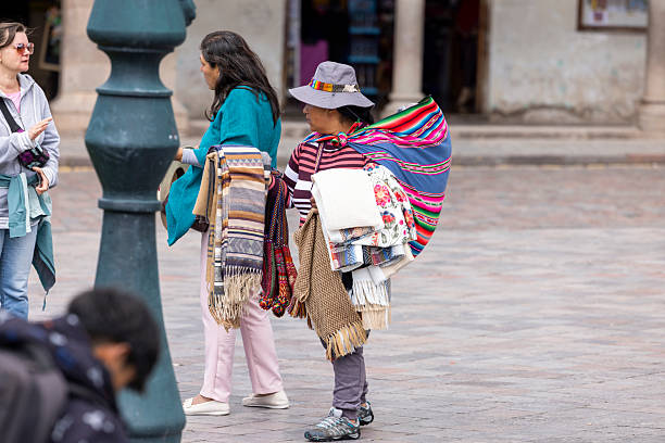 Peru, Cusco-March 13,2025: Local vendors work diligently in Cusco’s main square, selling handmade crafts and textiles