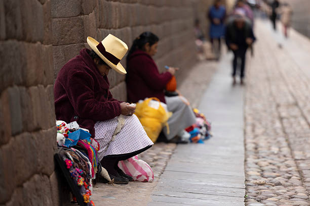 Peru, Cusco-March 13,2025: Local vendors work diligently in Cusco’s main square, selling handmade crafts and textiles