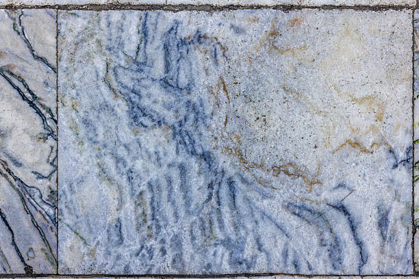 istock Worn Marble Floor Tiles with Blue and Gold Veins 2209837210