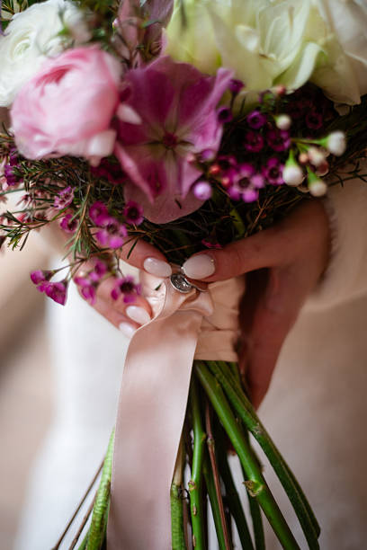 istock Beautiful wedding bouquet held by a bride indoors 2209840990