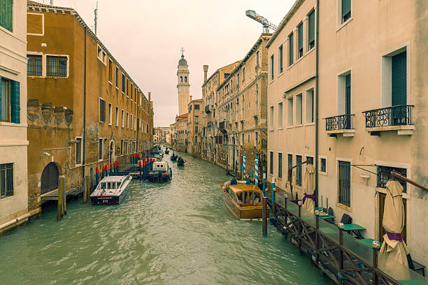 VENICE, ITALY- OCTOBER 30, 2018: Traditional narrow canal with gondolas in Venice, Italy