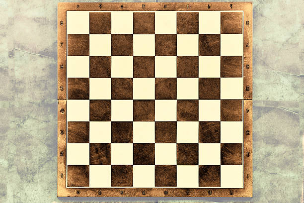 istock Brown wooden chessboard on a gray background. space for text 2209843292