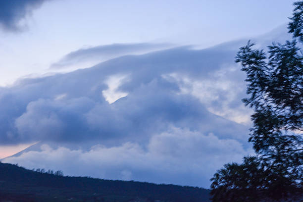 The mountain landscape looks charming surrounded by clouds