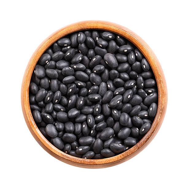 Dried black beans, turtle beans in a wooden bowl
