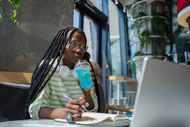 istock Female student types on laptop performing homework in cafe 2209848583