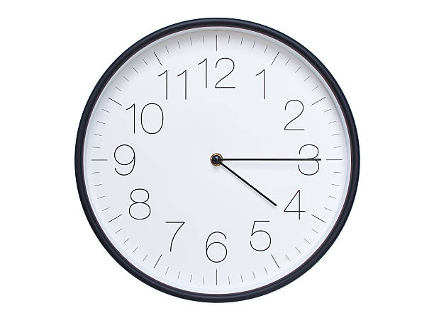 Simple wall clock with black frame and white face displaying 04:15 or 16:15. Ideal for time, schedule, and punctuality themes.
