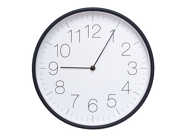 istock Simple wall clock with black frame and white face displaying 09:05 or 21:05. Ideal for time, schedule, and punctuality themes. 2209850585