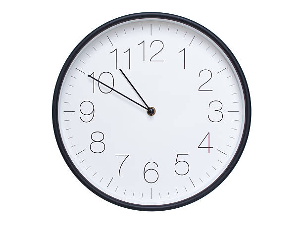 istock Simple wall clock with black frame and white face displaying 10:50 or 22:50. Ideal for time, schedule, and punctuality themes. 2209850661