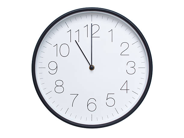 istock Simple wall clock with black frame and white face displaying 11:00 or 23:00. Ideal for time, schedule, and punctuality themes. 2209850664