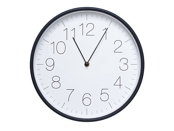 istock Simple wall clock with black frame and white face displaying 11:05 or 23:05. Ideal for time, schedule, and punctuality themes. 2209850670