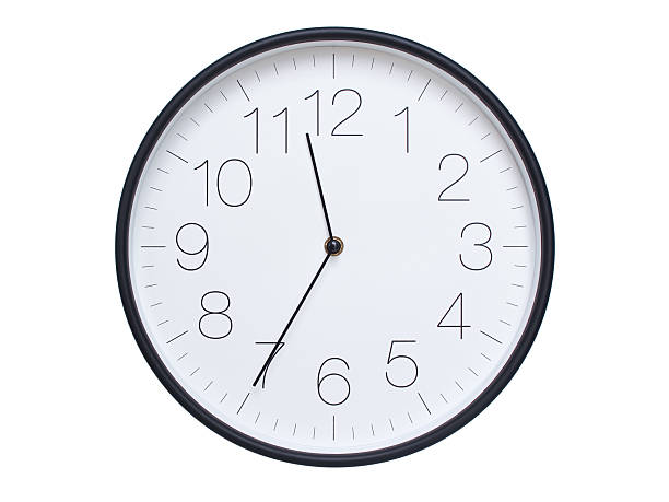 istock Simple wall clock with black frame and white face displaying 11:35 or 23:35. Ideal for time, schedule, and punctuality themes. 2209850696