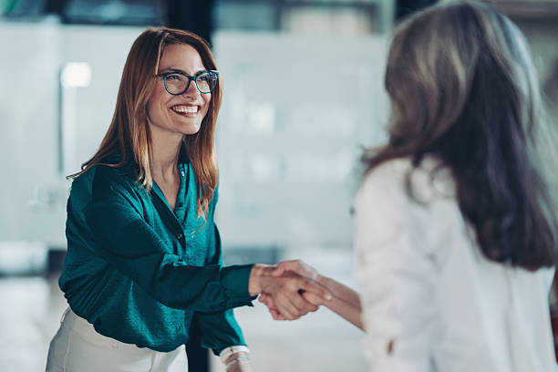 istock Businesswoman greeting a customer 2209851512