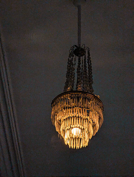 istock Vintage chandelier hanging from a high ceiling 2209852115