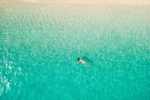 istock Woman floating on sea surface and enjoying on vacation 2209853757