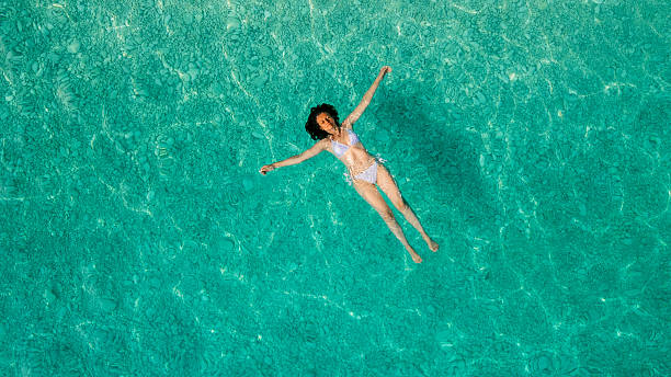 istock Woman floating on sea surface and enjoying on vacation 2209853762