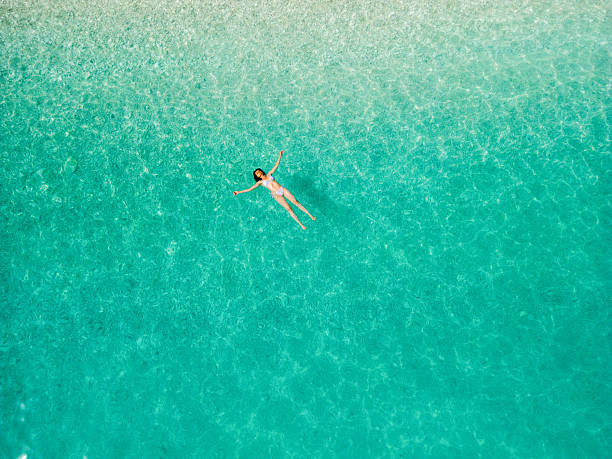 istock Woman floating on sea surface and enjoying on vacation 2209853765