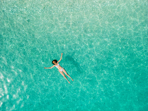 istock Woman floating on sea surface and enjoying on vacation 2209853771