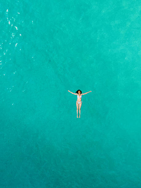 istock Woman floating on sea surface and enjoying on vacation 2209853796