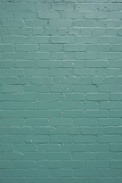 Close-up on an old painted brick wall.
