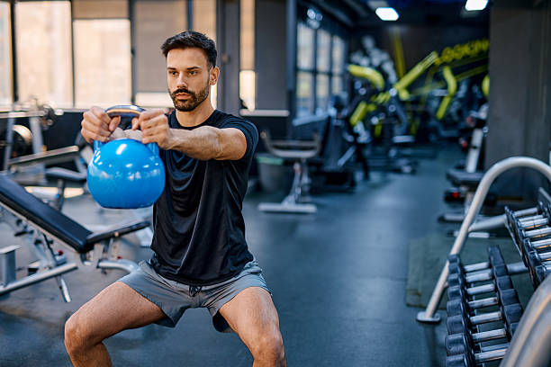 istock Determined athlete performing kettlebell squats in gym 2209855457