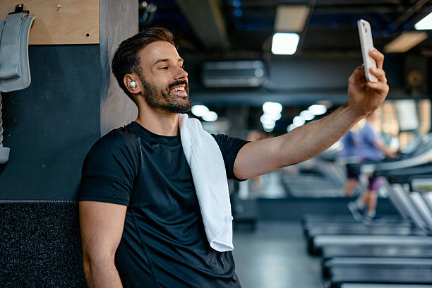 istock Young athletic man taking a selfie at the gym after workout 2209855583