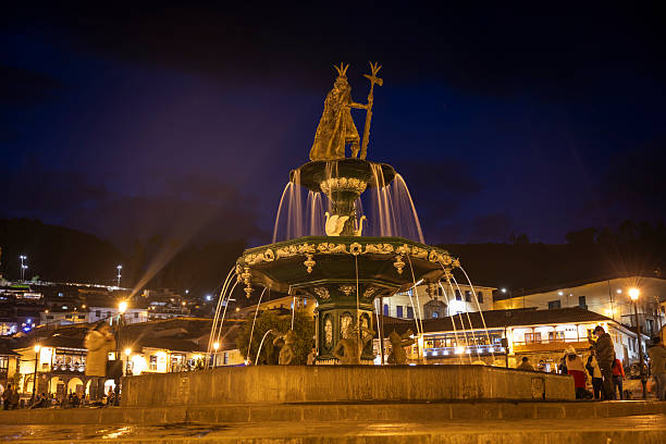 Baroque church behind decorative fountain in historic city plaza. Architectural detail of colonial facade. Urban square popular with tourists and locals.