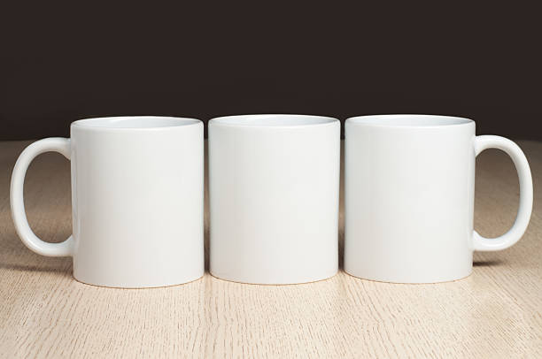 Three Blank 11oz white mugs on on the table. Mugs mockup