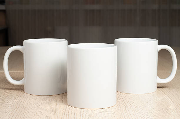 istock Three Blank 11oz white mugs on on the table. Mugs mockup 2209856293