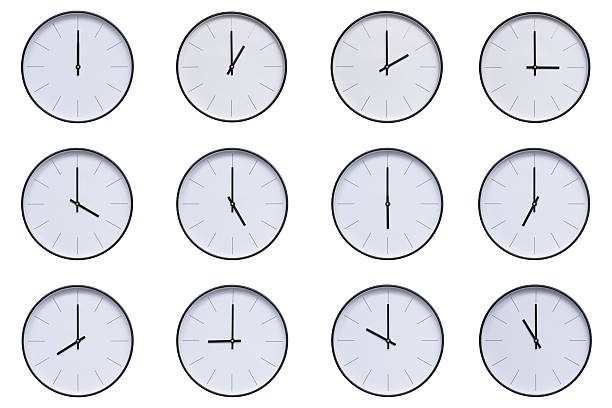 istock A set of 12 wall clocks with black frames and clean white faces, displaying a different time interval from 00:00 to 11:00 or 12:00 to 23:00. The modern and clean design makes this set ideal for themes related to time, routine, punctuality, scheduling, or 2209856570