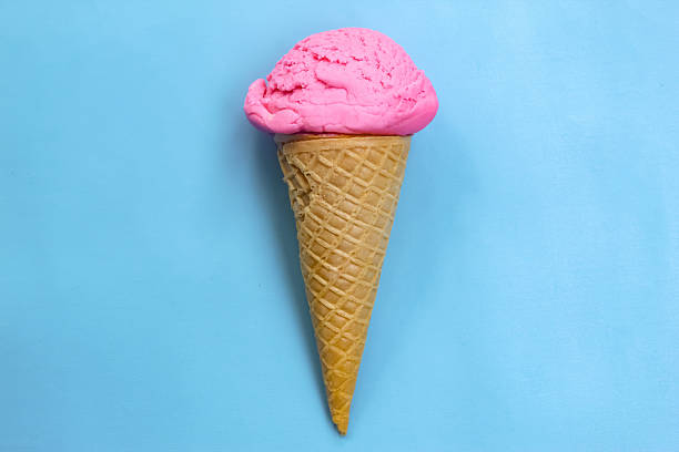 strawberry flavored ice cream cone on blue background