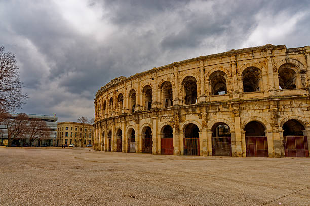 Nimes, France – Feb 19, 2025: The empty place in front of Nimes’ roman amphitheater