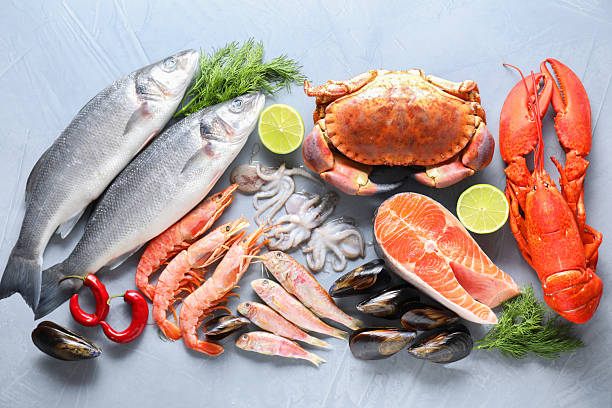 istock Many different sea food on grey textured table, flat lay 2209865654