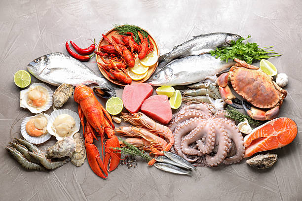 istock Many different sea food, herbs and lime on grey textured table, flat lay 2209865712