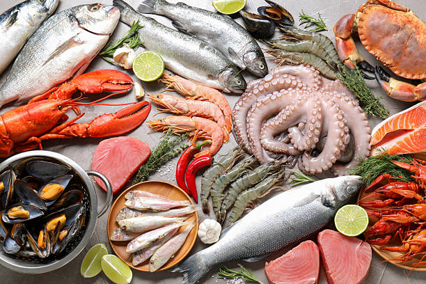 istock Many different sea food, herbs and lime on grey table, flat lay 2209865714