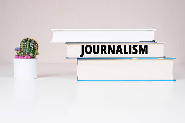 istock Journalism inscription books background 2209866429