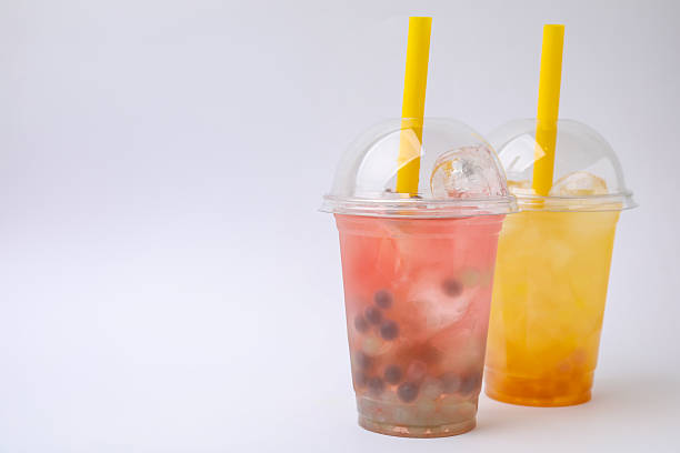 istock Tasty bubble tea in plastic cups on white background 2209869426