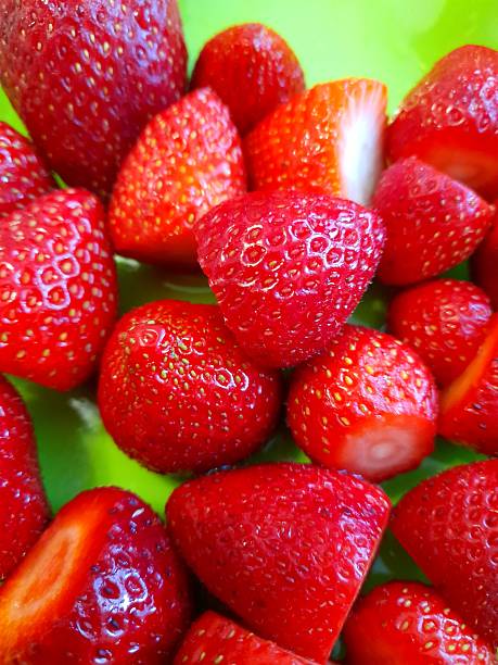 Strawberries on green plate close up