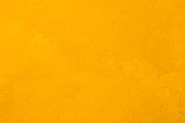istock Yellow textured stucco wall with rough plaster surface and warm vibrant color 2209891772